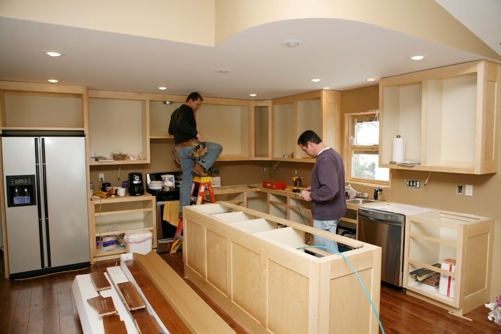 two men remodeling a kitchen of homes for sale in malibu ca